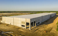 Drone construction photography documenting the progress and site context of a commercial building project.