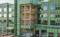 Construction aerial photography providing an elevated view of the building, site conditions, and surrounding property.